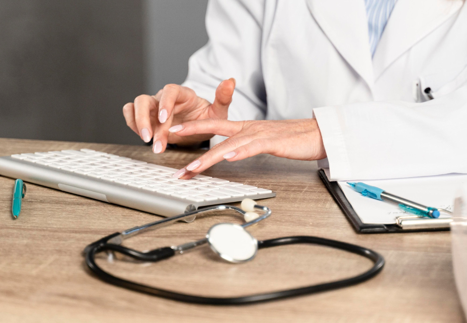 Doctor typing clinical notes for The Prep Rooms GP pathway Doctor typing clinical notes for The Prep Rooms GP pathway